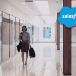 Screenshot of a woman carrying a satchel down a hallway with the salesforce logo overlaying the image.