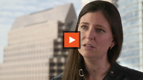 Video image of Lisa speaking about their customer service video platform and standing in front of skyscrapers.